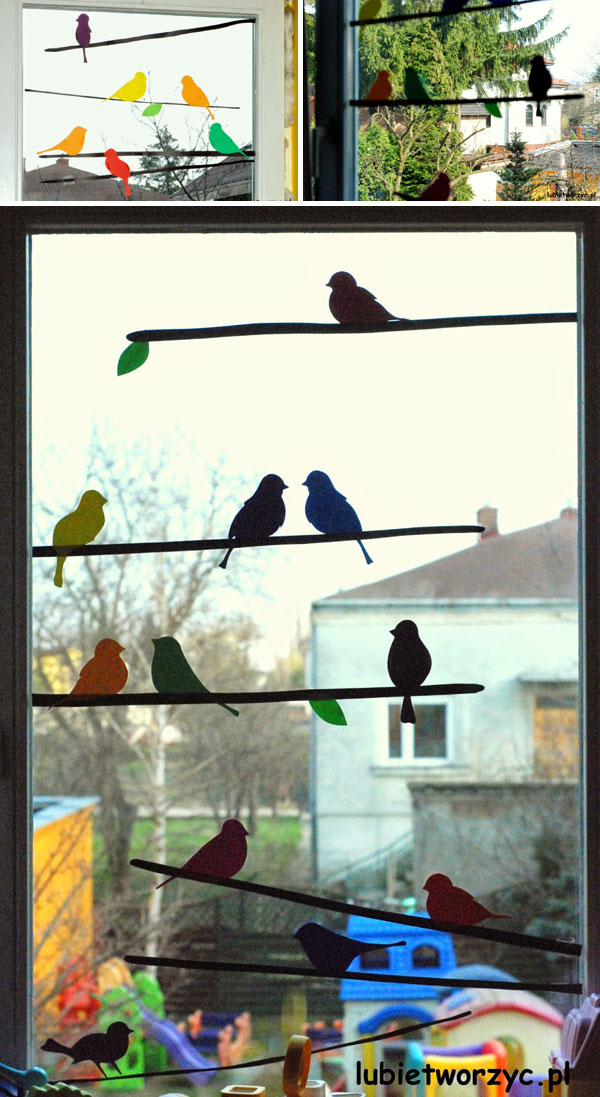 Colored sparrow and branches silhouettes on windows