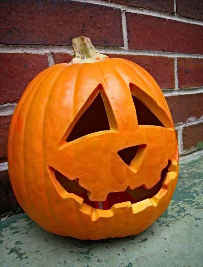 This is a perfect example of a classic pumpkin carving, with its friendly triangle eyes and wide smile.