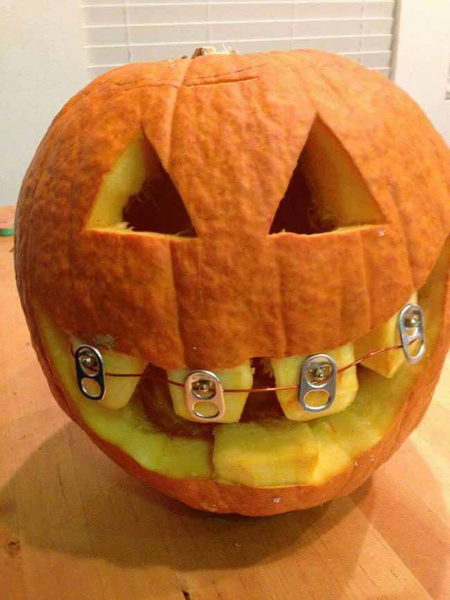 This goofy-grinned pumpkin is wearing braces made out of soda can tabs and wire.