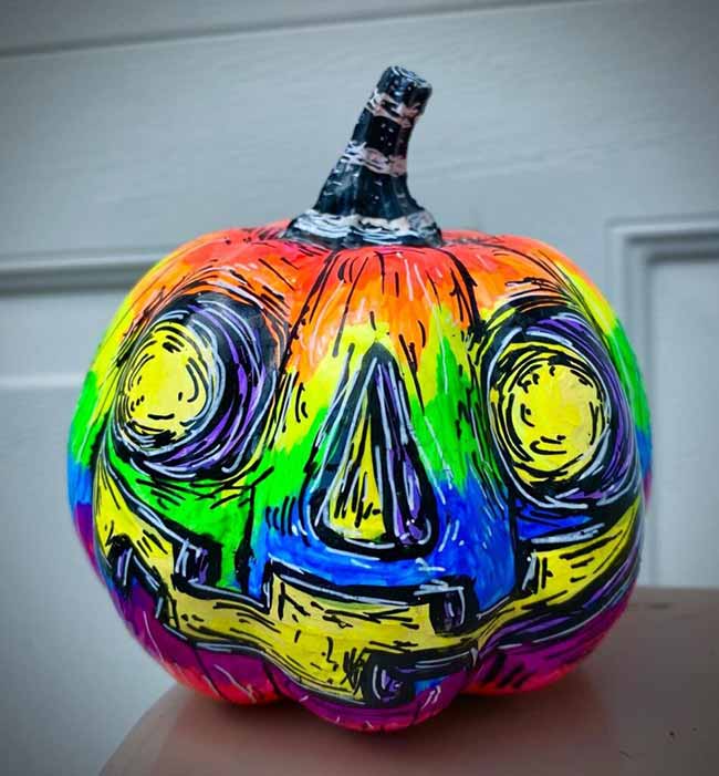 A jack-o'-lantern is covered in a vibrant, psychedelic rainbow of colors, with heavy black sketch lines giving it a chaotic and artistic look.