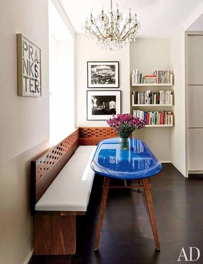 A long bench is perfect for narrow rooms. It tucks against the wall and offers plenty of seating without the clutter of chairs. Pair it with a slim, light table and the whole space feels open.
