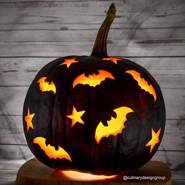For a dramatic look, this pumpkin was painted black, which makes the glowing bat and star cutouts stand out even more.