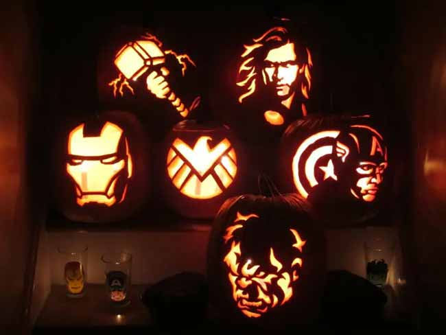 This collection of pumpkin carvings features several characters from the Avengers, including Hulk, Iron Man, and Captain America.
