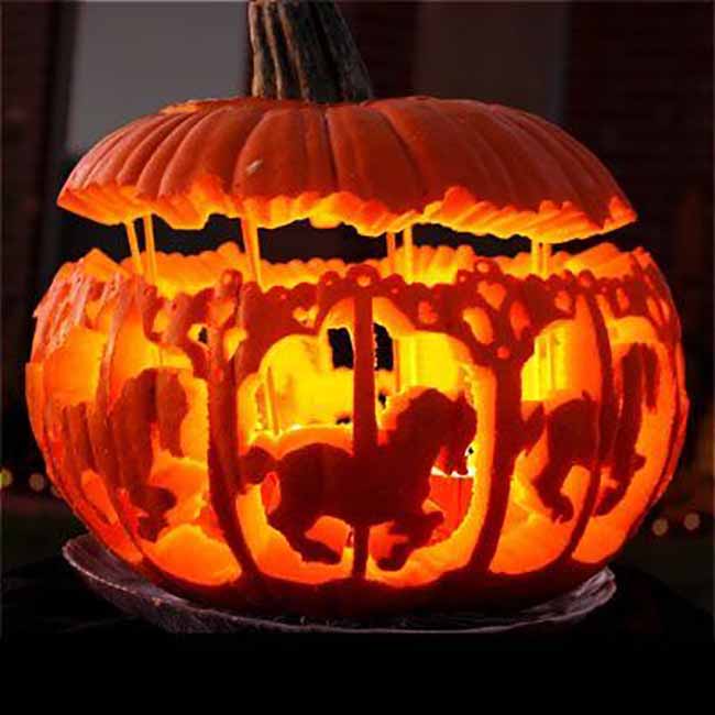 This incredibly detailed pumpkin carving looks just like a carousel, with horses lit up and spinning inside. The top of the pumpkin is a separate piece, acting as the ride's roof.