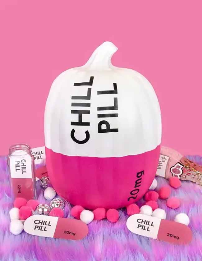 This pumpkin is painted half white and half bright pink, with “CHILL PILL” and “20mg” printed on it to mimic a medicine capsule.